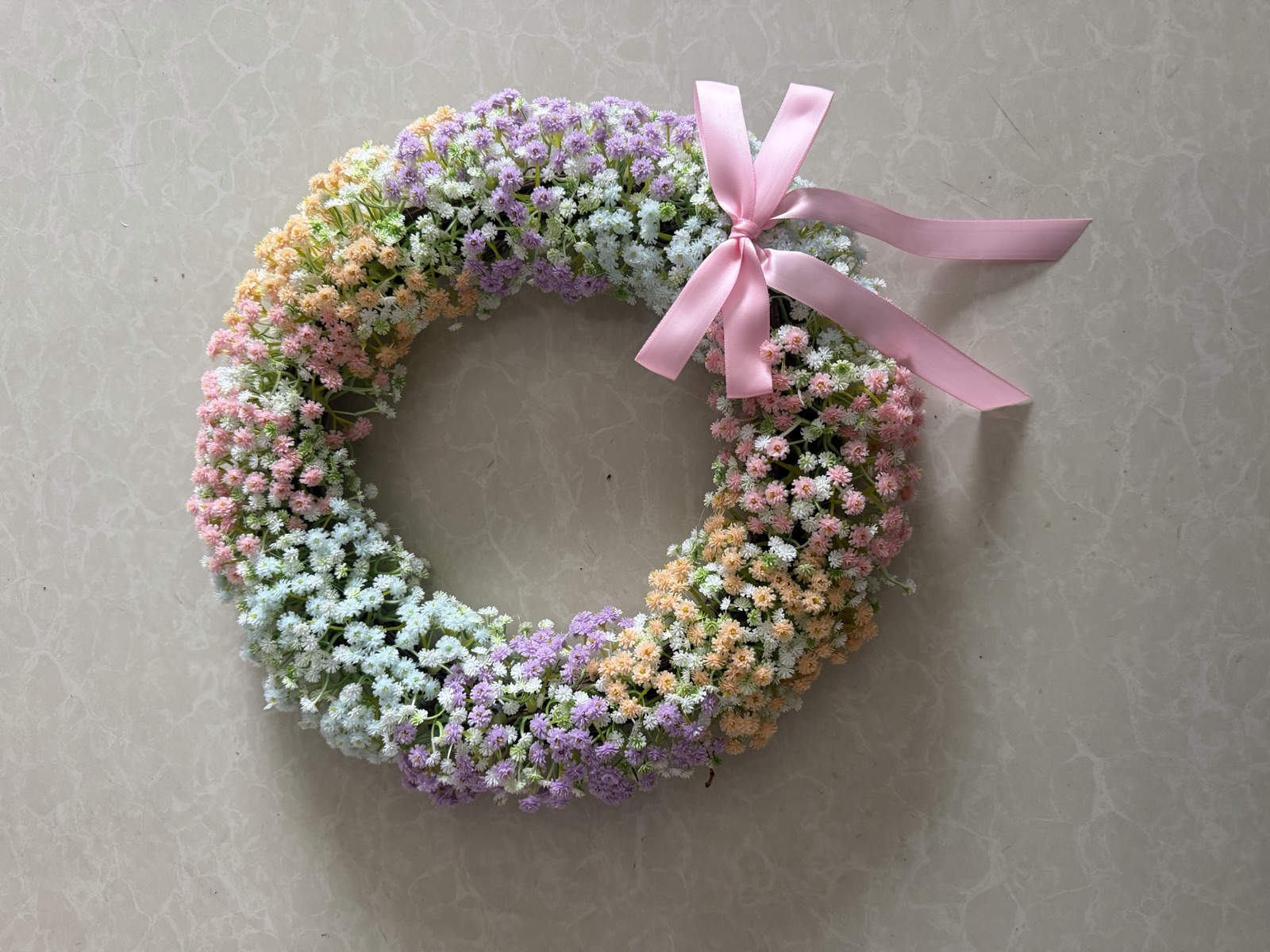 Pastel floral wreath with pink ribbon